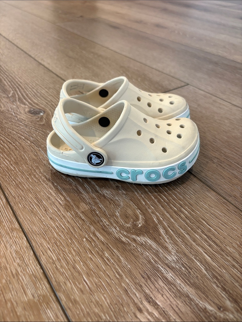 Toddler cream and aqua colored Crocs with Crocband size C9